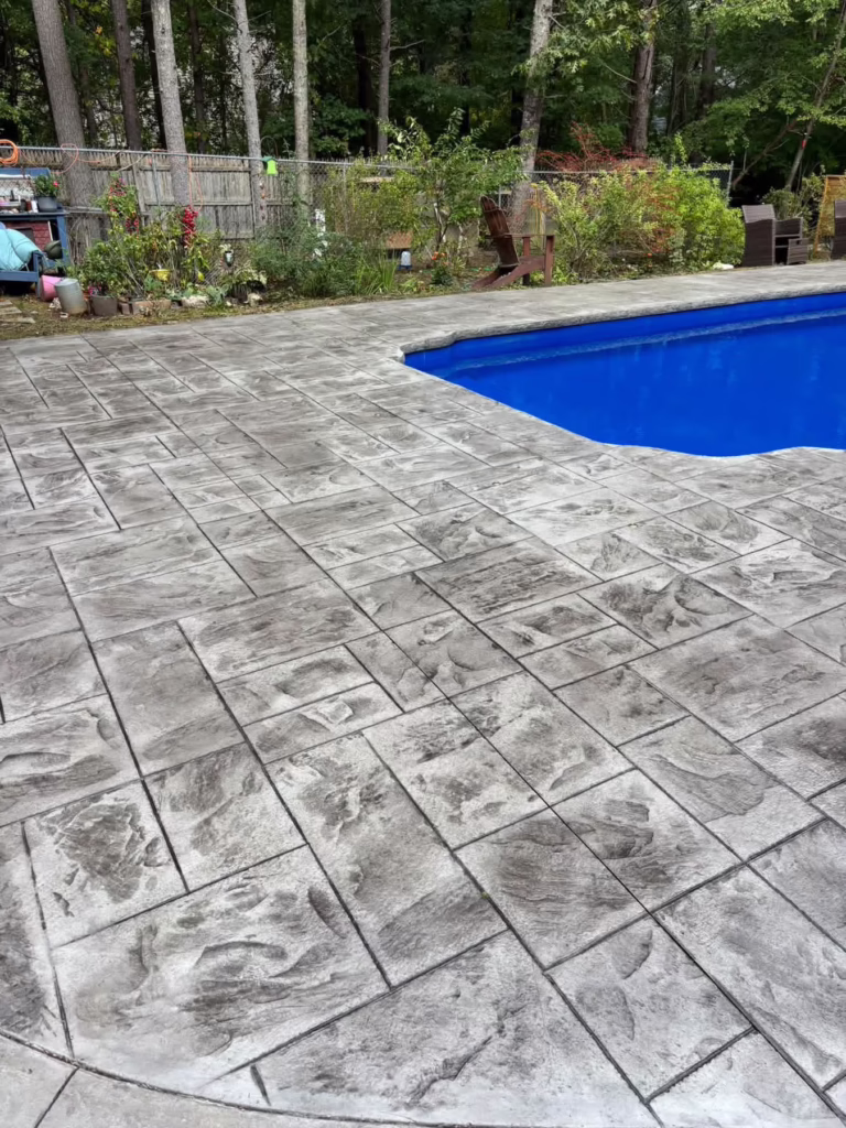Stamped concrete pool deck by Oliveira’s Decorative Concrete