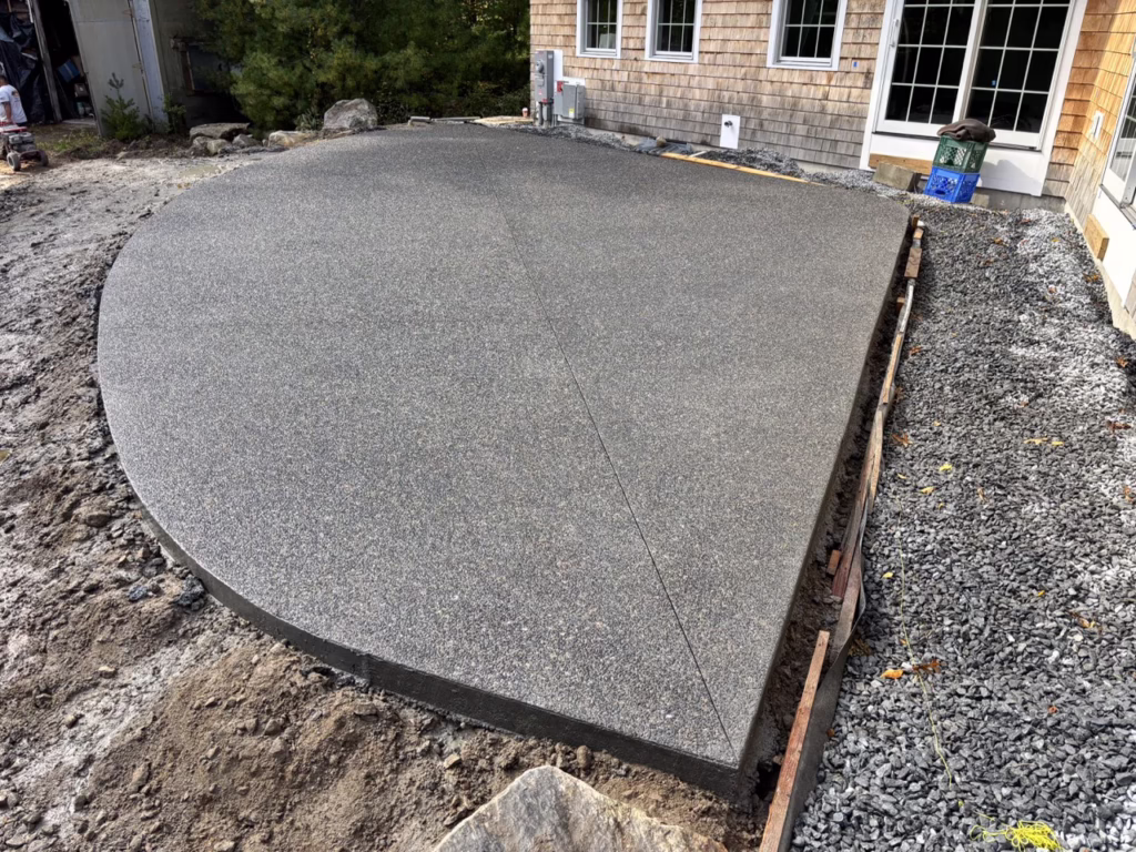 Freshly poured exposed aggregate concrete patio