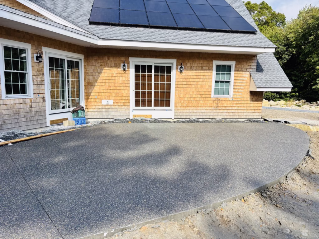 Curved exposed aggregate concrete patio